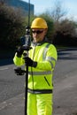 Site engineer doing road survey using modern robotic total station EDM before beginning of construction works