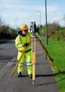 Site engineer installing tacheometer above control point before performing setting out for construction works and as build survey