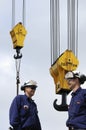 Site workers and crane hooks Royalty Free Stock Photo