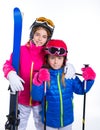 Siters kid girls with ski poles helmet and snow goggles