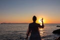 Sithonia - Silhouette of tourist woman with panoramic view of sunset over Aegean Mediterranean Sea on Karydi beach, Greece Royalty Free Stock Photo
