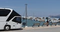 Modern tour bus on the seafront in Sitia an eastern Crete resort. Royalty Free Stock Photo