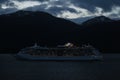 Royal Caribbean cruise ship at night cruising along the Alaskian Mountians