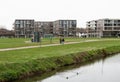 Sittard, Limburg, The Netherlands - The Keutel creek at the suburbs of the city with contemporary apartmetn blocks in the