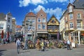 View on market suqare with exterior busy street cafes, traditional colorful houses, blue sunny sky