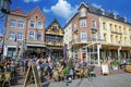 View on market suqare with exterior busy street cafes, traditional colorful houses, blue sunny sky Royalty Free Stock Photo