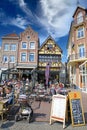 View on market suqare with exterior busy street cafes, traditional colorful houses, blue sunny sky