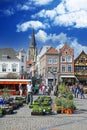 Sittard, Netherlands - March 25. 2022: View on traditional local farmer market square in ancient town, colorful old buildings on s