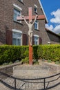 Sittard, South Limburg / Netherlands. August 4, 2020. Wooden cross with the statue of Jesus crucified on a brick base