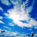 Sitting on the airplane that was flying and looking out at windows see beautiful skyline, clouds and land. Feeling freedom.