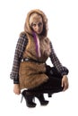 Sitting blonde in brown fur jacket with hood