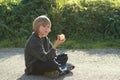 Sitting boy eating an apple Royalty Free Stock Photo