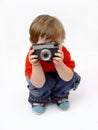 Sitting boy and photo camera