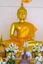 Sitting Buddha golden statue inside the wat thai temple