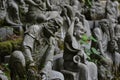 The Sitting Buddha between hundreds of Buddha statues of Japanese style.