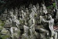 The Sitting Buddha between hundreds of Buddha statues of Japanese style