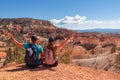 Bryce Canyon - Sitting couple with scenic aerial view from Fairyland hiking trail on massive hoodoo sandstone rock formations Royalty Free Stock Photo