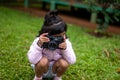 Sitting down A Little Girl Taking Pictures with DSLR Camera Royalty Free Stock Photo