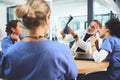 Sitting down for some medical problem solving. a team of doctors analysing x-rays during a meeting in a hospital. Royalty Free Stock Photo