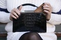 Black art deco crocodile purse and white sweater fashion detail Royalty Free Stock Photo