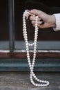 Female hand holding pearls outdoor fashion stillife Royalty Free Stock Photo