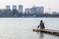 Sitting fisherman scenic autumn urban landscape