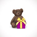 Sitting fluffy cute brown teddy bear with purple gift box with yellow bow. Children`s toy isolated on a white background. Royalty Free Stock Photo