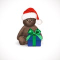 Sitting fluffy cute brown teddy bear with red christmas santa claus hat and blue gift box with green bow. Children`s toy isolated Royalty Free Stock Photo
