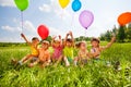 Sitting funny kids with balloons in the air Royalty Free Stock Photo