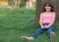 Sitting girl against the tree Royalty Free Stock Photo