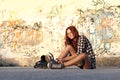 Sitting girl with roller skates on graffiti background Royalty Free Stock Photo