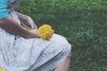 Sitting girl in vintage dress holding bunch of yellow dandelions Royalty Free Stock Photo