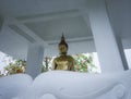 Sitting golden buddha in the white temple city of chiang rai. travel in thailand Royalty Free Stock Photo