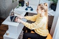 Sitting on gym ball at work. Use exercise ball like chair at workplace. Freelancer woman sitting on orange fitness ball