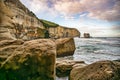 Sitting on a large boulder under the steep cliff  at Tunnel beach Royalty Free Stock Photo