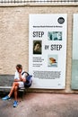 A sitting man and National Museum poster, Monaco Royalty Free Stock Photo