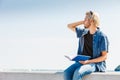 Sitting man reading book outside on sunny day Royalty Free Stock Photo