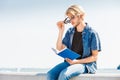 Sitting man reading book outside on sunny day Royalty Free Stock Photo