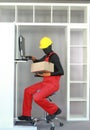 Sitting manual worker dealing with box at computer