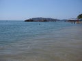 Sitting places, people and palm trees at sandy beach on bay of ACAPULCO city in Mexico with calm Pacific Ocean Royalty Free Stock Photo