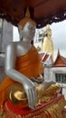 Sitting and standing posture Buddha sculptures in temple in Bangkok Royalty Free Stock Photo