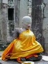 Sitting stone Buddha wrapped in golden cloth, Cambodia