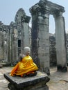 Sitting stone Buddha wrapped in golden cloth, Cambodia