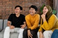 Sitting together on the couch laughing together Royalty Free Stock Photo