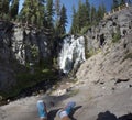 Tired sitting tourist watching the waterfall