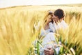 Sitting in the wheat. Happy people. Couple just married. Together on the majestic agricultural field at sunny day Royalty Free Stock Photo