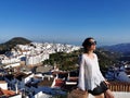 Sitting woman with a beautiful landscape in the background Frigiliana, Spain