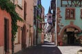 RIQUEWIHR, FRANCE - JULY 17, 2017: Picturesque street with traditional colorful houses in Riquewihr village on alsatian wine route Royalty Free Stock Photo