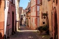 RIQUEWIHR, FRANCE - JULY 17, 2017: Picturesque street with traditional colorful houses in Riquewihr village on alsatian wine route Royalty Free Stock Photo