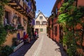 RIQUEWIHR, FRANCE - JULY 17, 2017: Picturesque street with traditional colorful houses in Riquewihr village on alsatian wine route Royalty Free Stock Photo